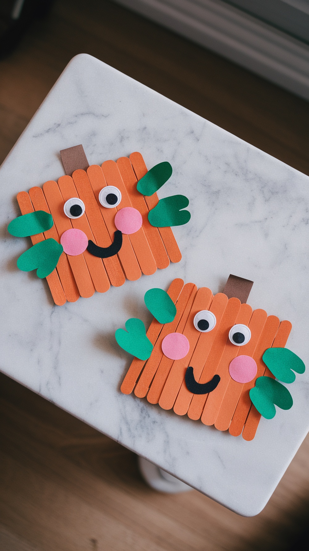 Colorful Popsicle Stick Pumpkin Faces on a table